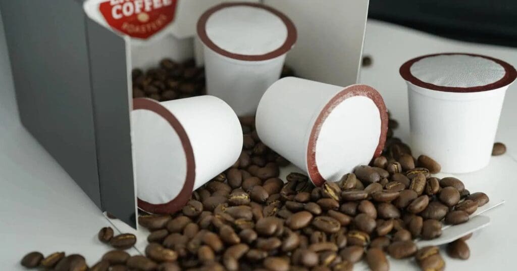 K-cups environmental impact showing used coffee pods and environmental effects" 
