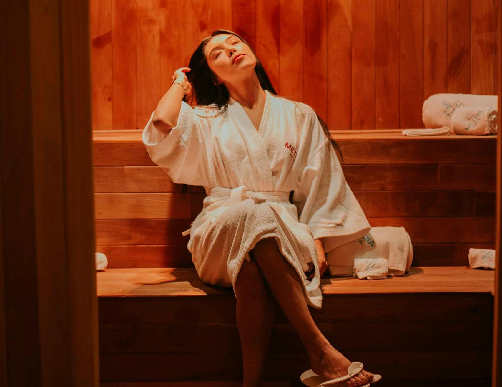 A Woman Wearing a Robe in a Sauna